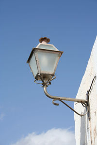 Low angle view of lamp post against blue sky