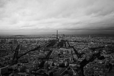 High angle view of buildings in city against cloudy sky