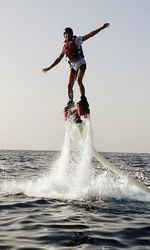 People surfing in sea