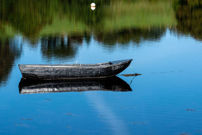 Boat moored on lake