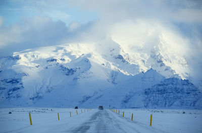 Scenic view of snow covered mountains against sky