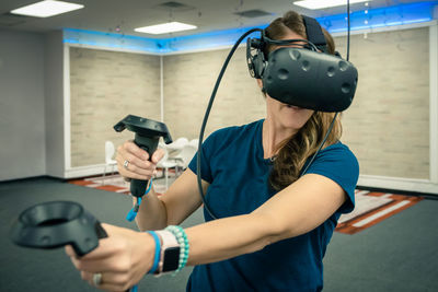 Mature woman using virtual reality at home