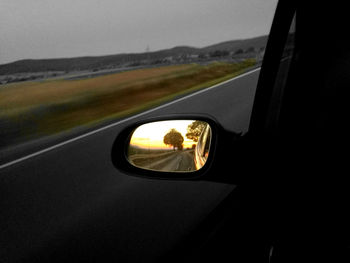 Reflection of car on side-view mirror