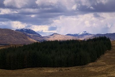 Scenic view of mountains against cloudy sky