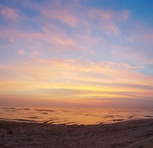 Scenic view of sea against romantic sky at sunset