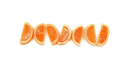 Close-up of orange fruit against white background