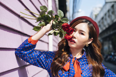 Portrait of woman holding flowers