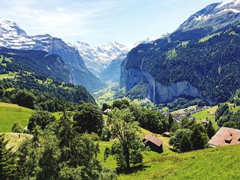 Scenic view of trees and mountains against sky