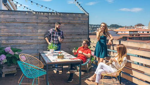 Friends enjoying together at rooftop restaurant