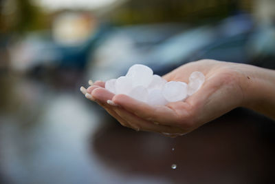 Cropped hand of person pouring water