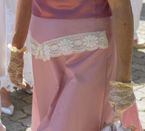 Midsection of woman standing against wall