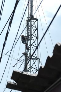 Low angle view of electricity pylon against sky