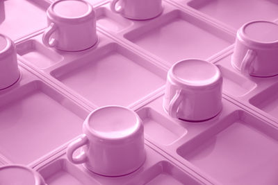 Close-up of pink coffee cups in tray