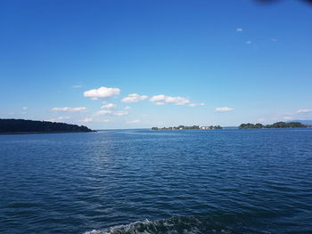 Scenic view of sea against blue sky