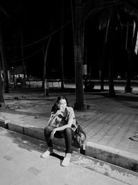 Portrait of young woman sitting on bench