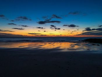 Scenic view of beach against sky during sunset