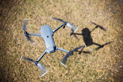 High angle view of drone flying over field