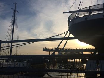 View of cranes against sky at sunset