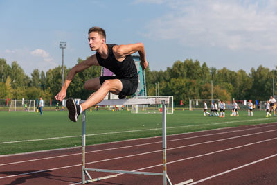 Full length of man exercising on soccer field