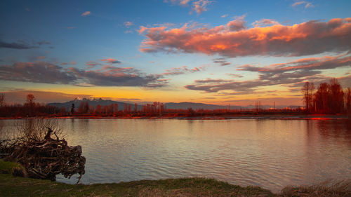 Scenic view of lake against sky during sunset