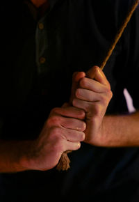 Midsection of man holding knife