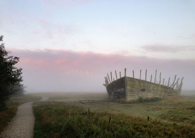 Built structure on field against sky