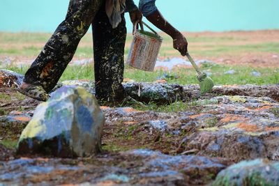 Low section of man working on field