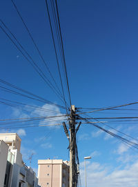 Low angle view of electricity pylon against sky