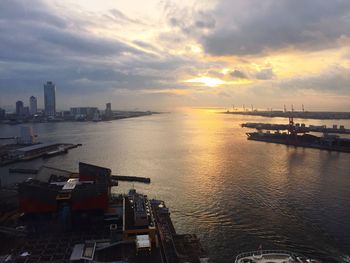 View of city at waterfront during sunset