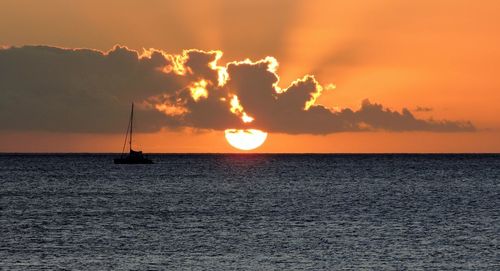Scenic view of sea against orange sky