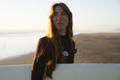 Surfer girl on the beach near tofino