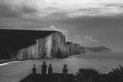 Scenic view of beach against cloudy sky