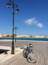 Bike parked against blue sky