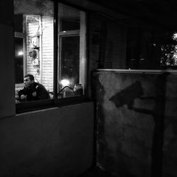 Man sitting in corridor of building