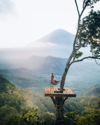 High angle view of woman standing on tree house