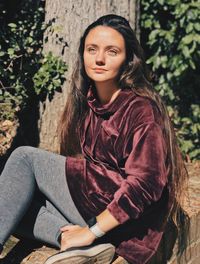 Portrait of young woman sitting outdoors