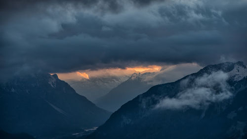 Scenic view of mountains against cloudy sky