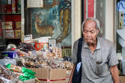 Portrait of man standing at market