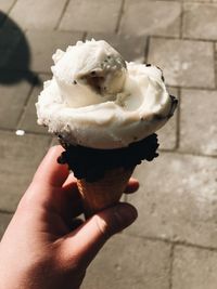 Close-up of hand holding ice cream cone