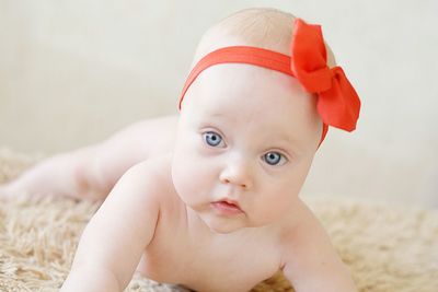 Close-up portrait of baby lying on blanket