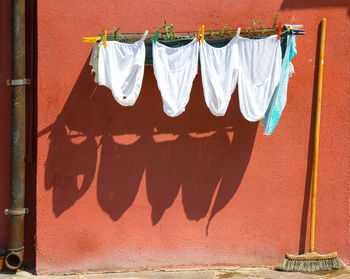 Clothesline hanging from wall