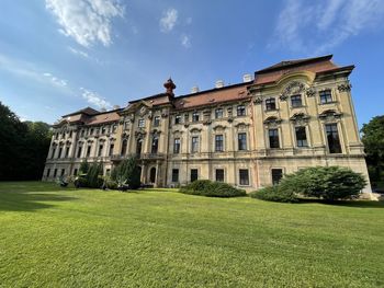 Building by lawn against sky
