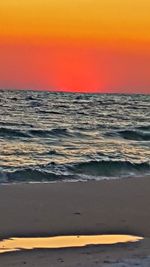 Scenic view of sea against orange sky