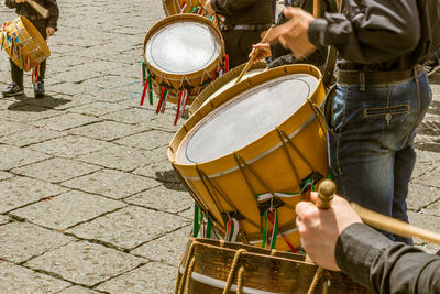 Musicians playing drums on street in city