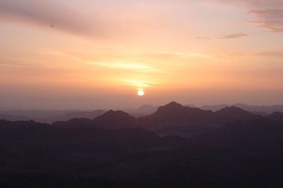 Scenic view of silhouette mountains against sky at sunset