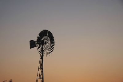 Low angle view of silhouette windmill against sky during sunset