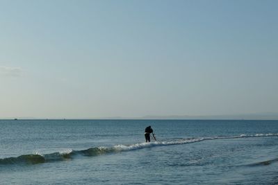 Fisherman fishing in sea at beach