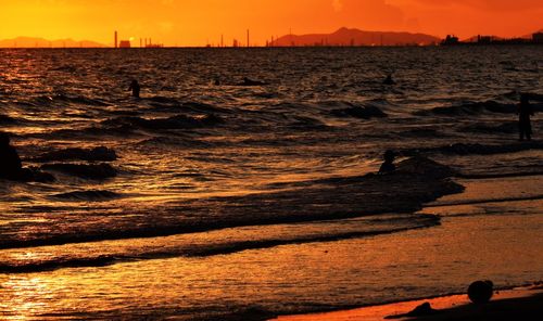 Scenic view of beach against sky during sunset