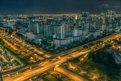 High angle view of illuminated city buildings at night