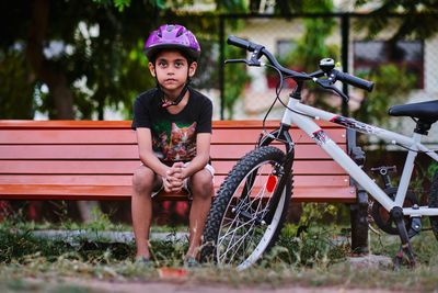 Portrait of boy sitting on bench